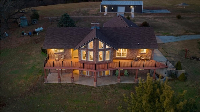 15262 Shipe Rd, Gravette, AR 72736 - back of property with a patio, a yard, a wooden deck, and an outbuilding