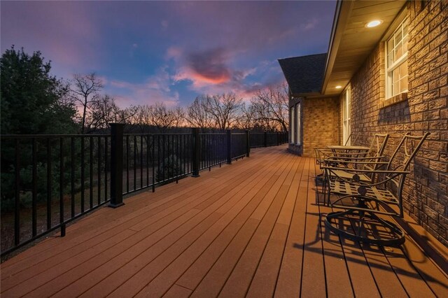 15262 Shipe Rd, Gravette, AR 72736 - deck at dusk featuring outdoor dining space