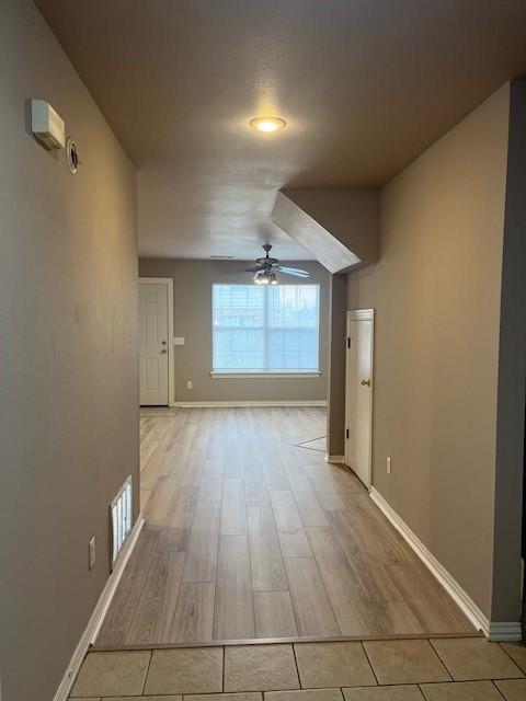 interior space with ceiling fan and light wood-type flooring