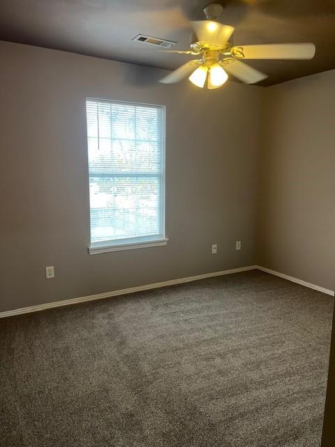 carpeted empty room featuring ceiling fan