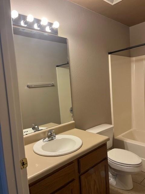 full bathroom with tile patterned flooring, vanity, bathing tub / shower combination, and toilet