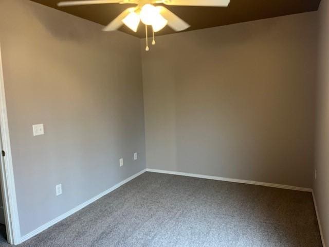 spare room featuring carpet and ceiling fan