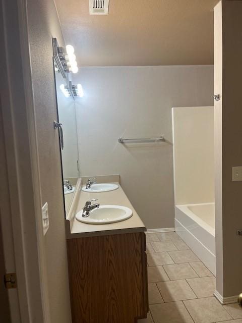 bathroom with tile patterned floors and vanity