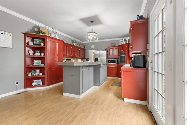 kitchen with plenty of natural light, a kitchen island, crown molding, and stainless steel appliances