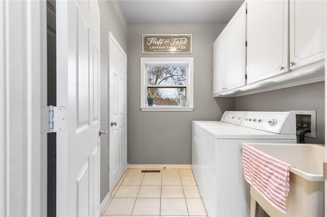 washroom featuring cabinets, light tile patterned floors, sink, and separate washer and dryer