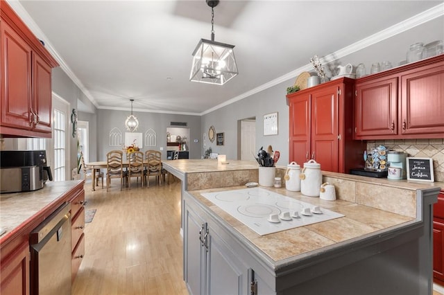 kitchen featuring white electric stovetop, dishwasher, a kitchen island, and crown molding