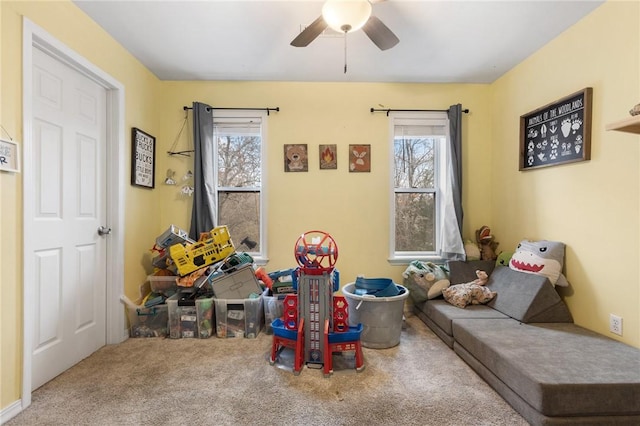 game room with carpet flooring and ceiling fan