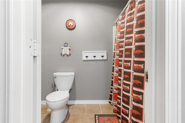 bathroom with tile patterned flooring and toilet