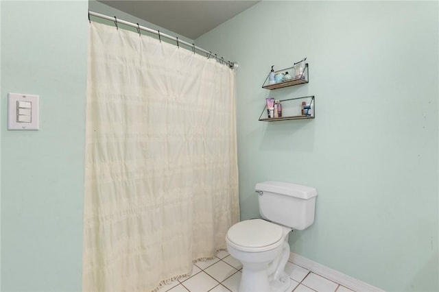 bathroom featuring tile patterned floors, curtained shower, and toilet