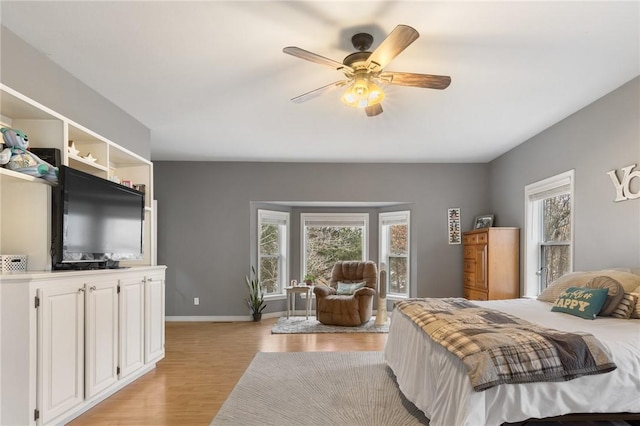 bedroom with ceiling fan and light hardwood / wood-style floors