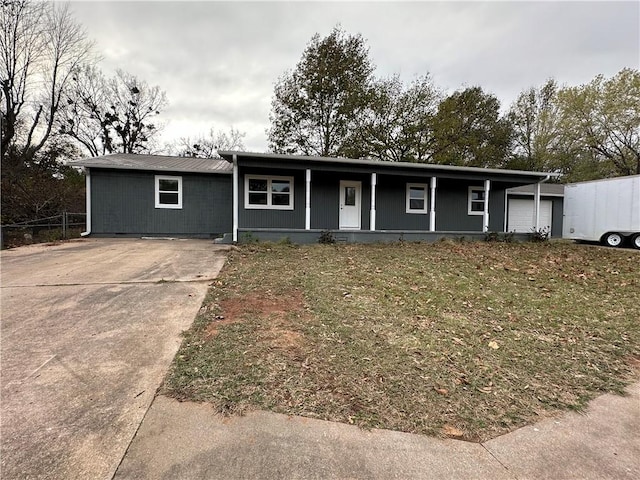 ranch-style house with covered porch and a front lawn