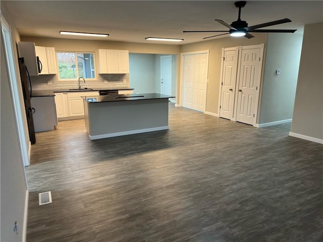 kitchen with dark hardwood / wood-style flooring, sink, and white cabinets