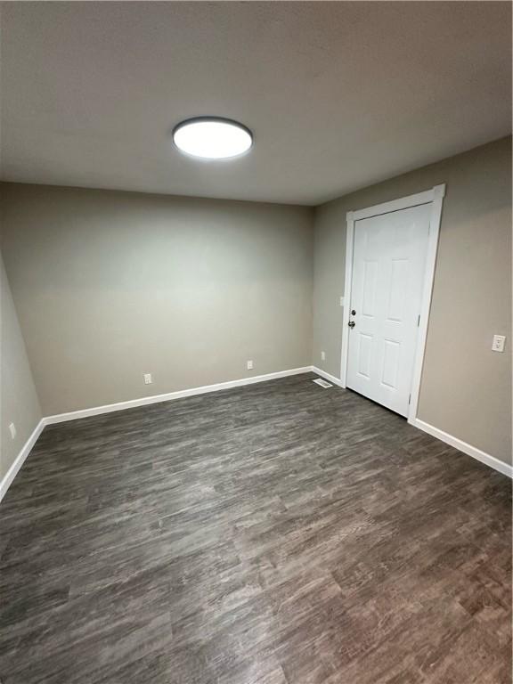 empty room featuring dark hardwood / wood-style flooring