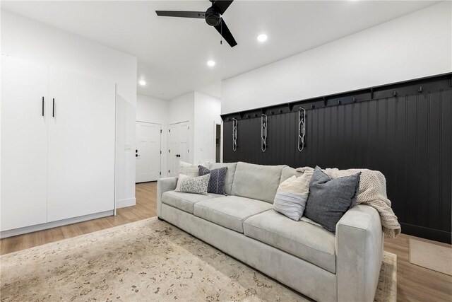 living room with light wood-type flooring and ceiling fan