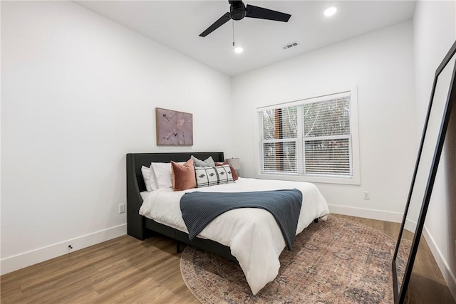 bedroom featuring visible vents, a ceiling fan, wood finished floors, recessed lighting, and baseboards