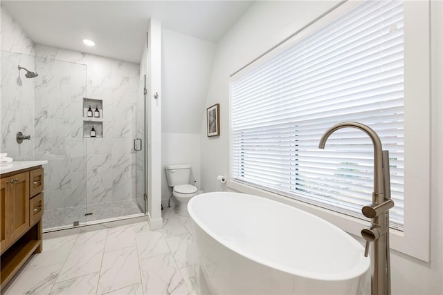 bathroom featuring marble finish floor, recessed lighting, a marble finish shower, a freestanding bath, and vanity