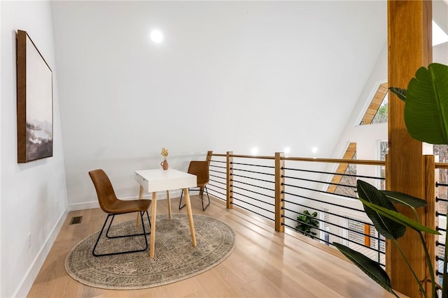 dining space featuring visible vents, baseboards, and wood finished floors