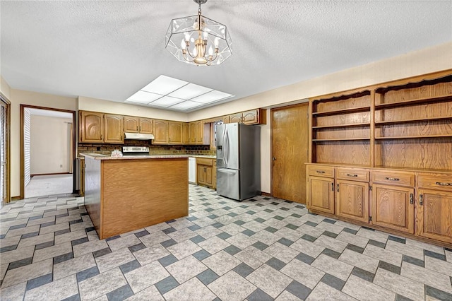 kitchen with a center island, hanging light fixtures, a notable chandelier, backsplash, and stainless steel fridge