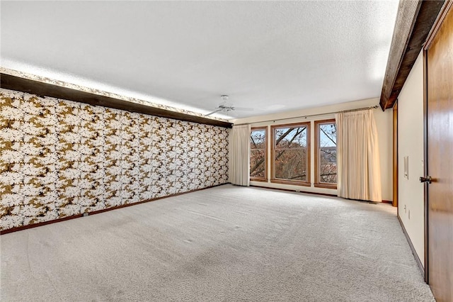 interior space featuring beamed ceiling, a textured ceiling, and ceiling fan