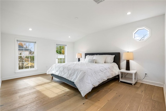 bedroom featuring vaulted ceiling and light hardwood / wood-style flooring