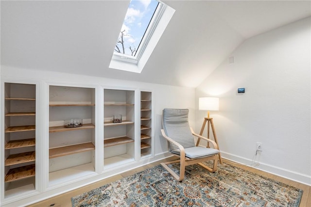 sitting room with wood-type flooring and vaulted ceiling