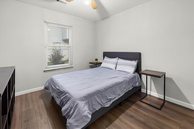 bedroom with ceiling fan and dark hardwood / wood-style floors