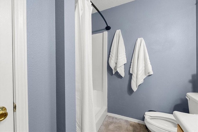 bathroom featuring a shower with shower curtain and toilet