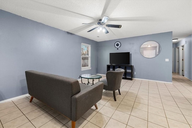 tiled living room featuring ceiling fan and a textured ceiling