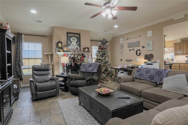 living room featuring ceiling fan and crown molding