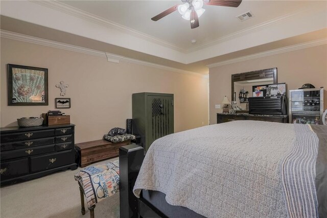 bedroom with a raised ceiling, ceiling fan, crown molding, and light colored carpet