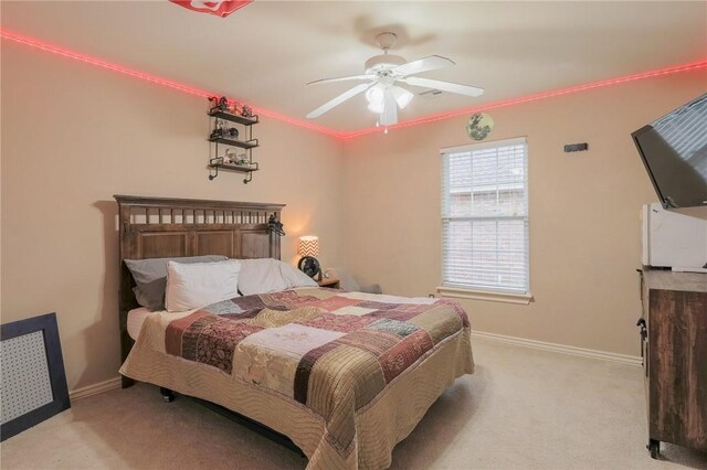 bedroom featuring light carpet and ceiling fan