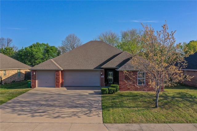view of front facade featuring a garage, brick siding, a front lawn, and concrete driveway