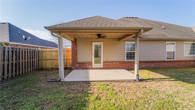 rear view of property with brick siding, ceiling fan, and a patio area