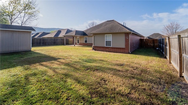 rear view of property with brick siding and an outbuilding