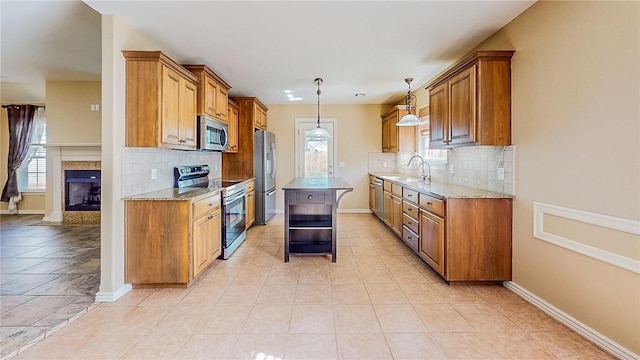 kitchen with stainless steel appliances, brown cabinets, decorative backsplash, and plenty of natural light