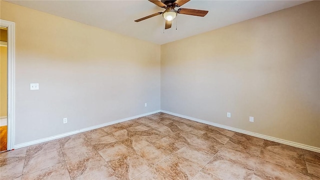 empty room featuring ceiling fan and baseboards