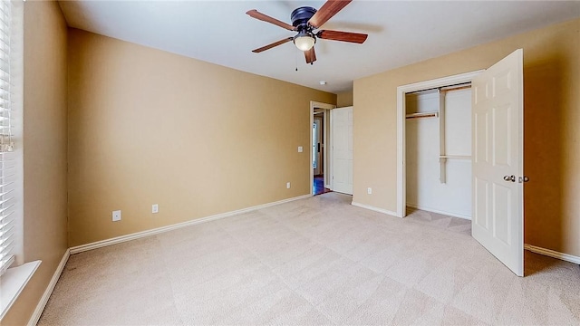unfurnished bedroom with light colored carpet, baseboards, and a closet