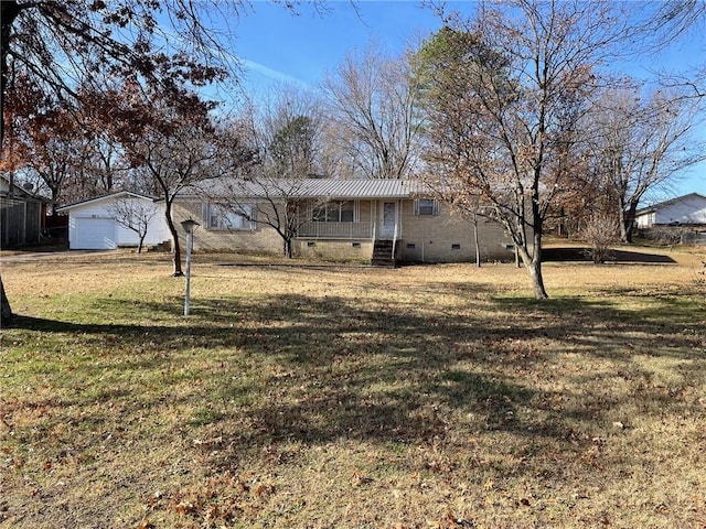 view of yard with a porch, a garage, and an outdoor structure