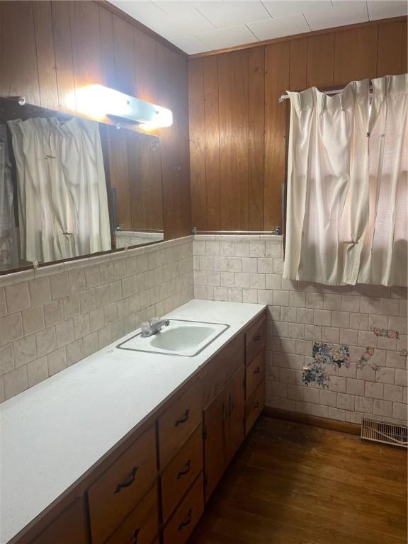 bathroom featuring vanity and wood-type flooring