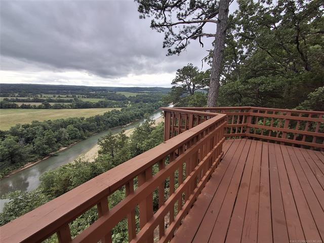 wooden terrace featuring a water view