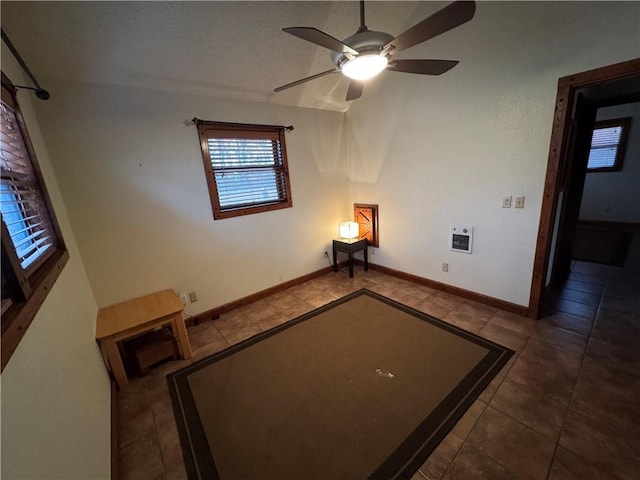 tiled empty room with ceiling fan