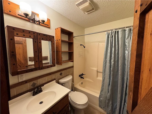 full bathroom featuring vanity, toilet, a textured ceiling, and shower / tub combo