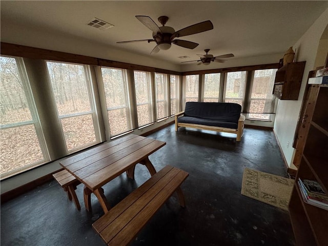 sunroom with ceiling fan