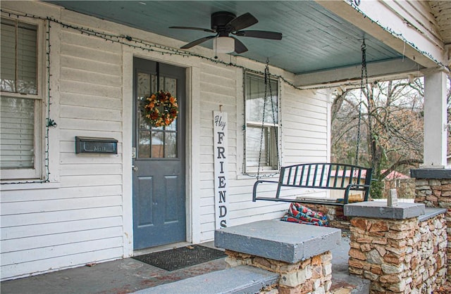 property entrance featuring ceiling fan and a porch