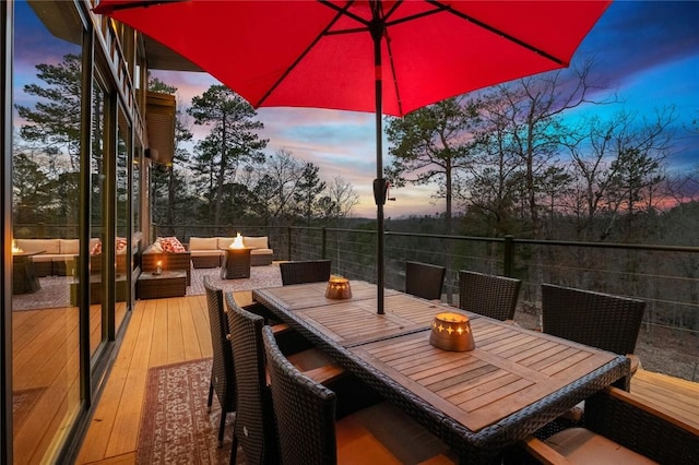 deck at dusk with an outdoor hangout area