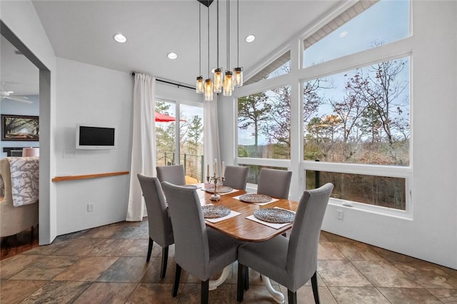 dining area featuring vaulted ceiling and a notable chandelier