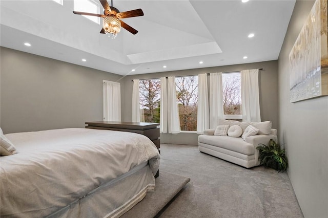 carpeted bedroom with ceiling fan and high vaulted ceiling