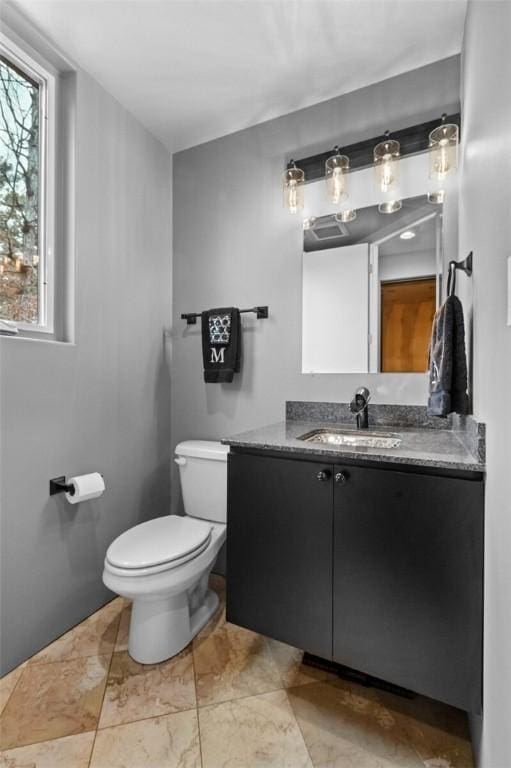 bathroom with vanity and toilet