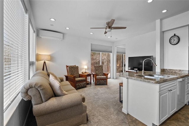 carpeted living room with a wall unit AC, a wealth of natural light, sink, and ceiling fan