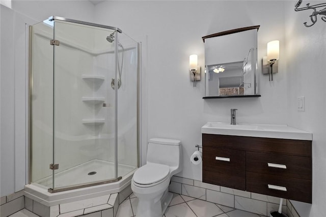 bathroom with toilet, vanity, tile patterned floors, and an enclosed shower